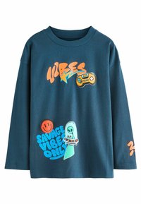 Mörkblå t-shirt med långa ärmar i bomull. Har färggrafik som inkluderar en spelkontroll, ett smiley-ansikte och ett utomjordiskt mönster.