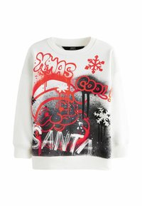 Vit sweatshirt med färggrafik, inklusive "JUL", "JULENISSE", snöflingor och en illustration av en julenisse med röda och svarta accenter.