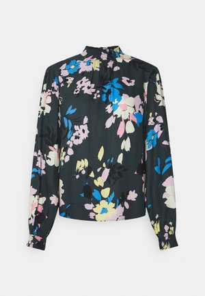 Chemisier noir à manches longues avec poignets élastiques et col montant, présentant un motif floral pastel en bleu, rose, jaune et crème.