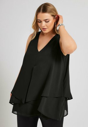 Top senza maniche nero con scollatura a V profonda, design a strati e tessuto leggero. La morbida trama e la vestibilità rilassata migliorano la caduta e il fluire.