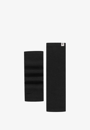 Two black knitted wrist warmers, one folded showing a thumb hole, the other flat with a small white label at the top edge.