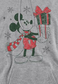 Gray hoodie featuring a distressed graphic of a cartoon mouse holding a Christmas gift, surrounded by snowflakes. Red and green accents.