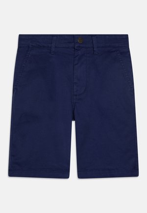 Calções azul-marinho feitos de tecido de algodão, com fecho de botão, dois bolsos frontais e bainha reta. Textura suave com minimalismo nos detalhes.