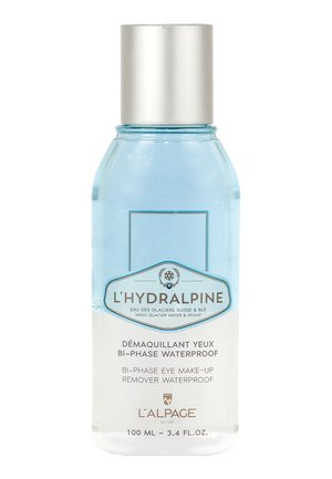 Liquido blu chiaro in una bottiglia di plastica trasparente con un tappo a vite argentato. L'etichetta presenta un design blu e bianco, riportante la dicitura "bi-fase impermeabile".