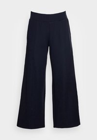 Široké kalhoty vyrobené z tmavého materiálu, s hladkou texturou, vysokým pasem a bez viditelných zapínání nebo ozdob.