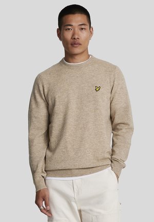 Maglione beige realizzato in tessuto a maglia, con scollatura rotonda e polsini a coste. Logo giallo ricamato ben visibile sul lato sinistro del petto.