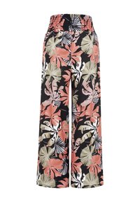 Pantalon noir à jambes larges avec taille élastique, imprimé de grandes feuilles et fleurs tropicales roses, beiges et blanches.