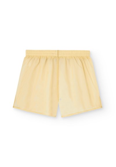 Gula tygshorts med elastisk midja, med en avslappnad passform och en slät textur. Inga fickor eller märkbara mönster synliga.