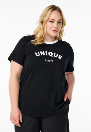 Mustas t-särk valge tekstiga "UNIQUE" ja "BEAUTÉ." Omab ümmargust kaelust kontrastse valge äärega ja lühikesi varrukaid. Mugav lõige.
