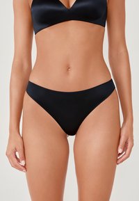 Black bikini briefs with a smooth satin finish, low-rise design, and minimalistic coverage. Features seamless edges and a sleek shape.