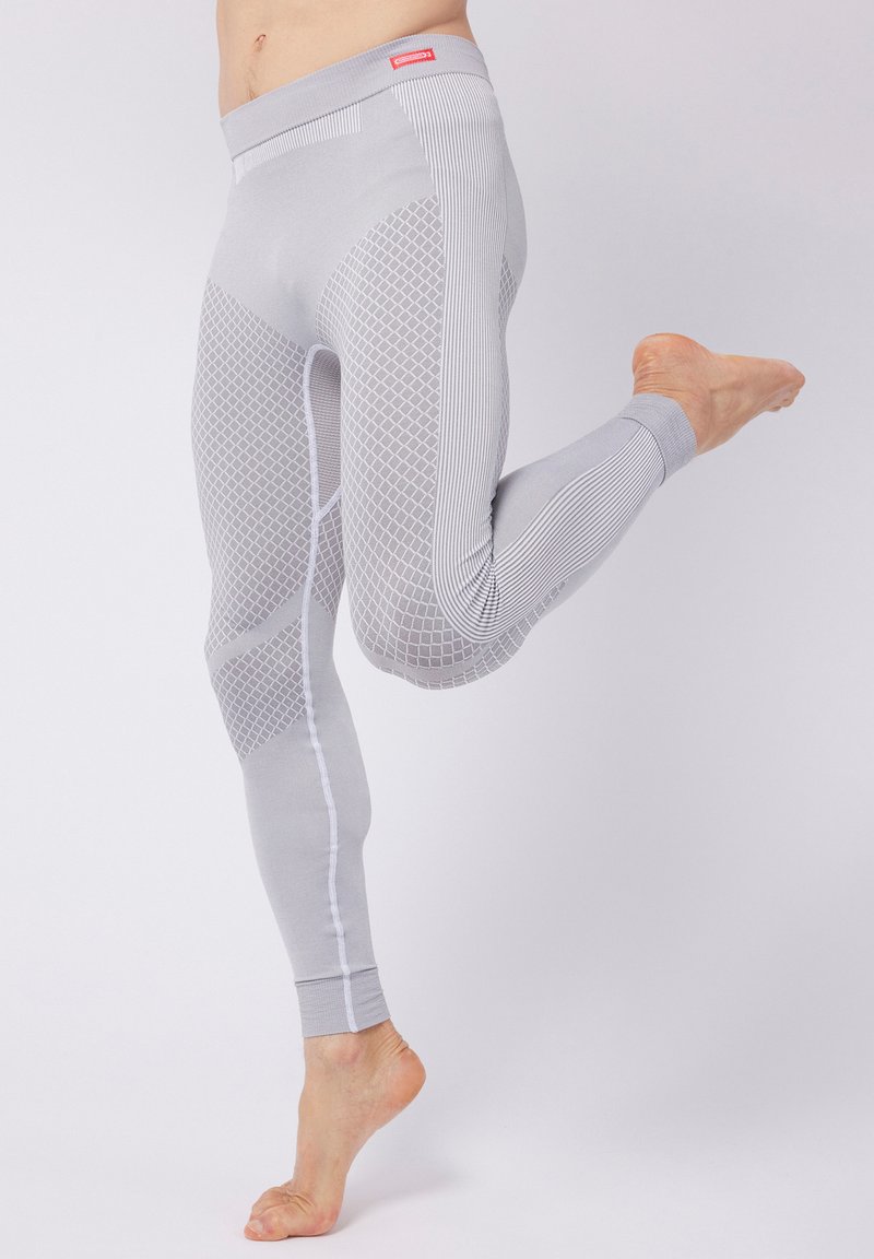 Leggings grigi con un motivo geometrico testurizzato, caratterizzati da sezioni a coste e una finitura liscia. Include un cinturino elastico a contrasto.