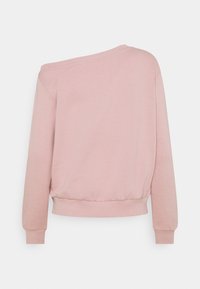 Felpa rosa chiaro con vestibilità rilassata, design scivolato sulle spalle, maniche lunghe, polsini a costine e orlo arrotondato. Tessuto morbido.