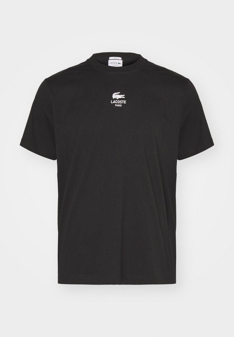 T-shirt noir à manches courtes et col rond avec logo blanc Lacoste Paris et emblème du crocodile centré sur la poitrine.