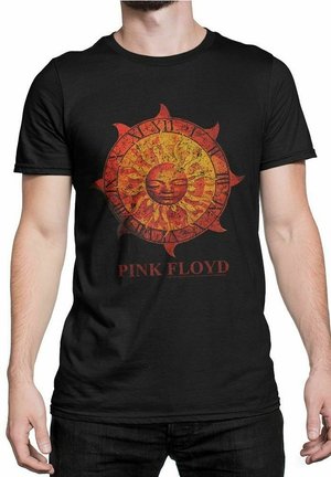 Sort T-shirt med et vintage design af en rød og gul solklokke samt romerske tal, med teksten "PINK FLOYD" under grafikken.