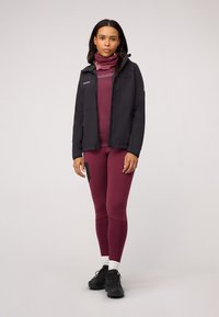 Black softshell jacket, maroon fitted top, and matching leggings. Accented with a pink neck gaiter and black footwear. Smooth textures throughout.