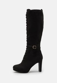 Black knee-high boots made of soft suede, featuring a front lace design and a buckle accent on the ankle. Stiletto heel adds height.