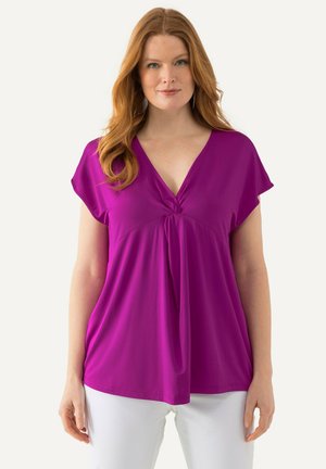 Blusa magenta a maniche corte con scollatura a V e dettaglio di nodo attorcigliato sul davanti; tessuto leggero con una texture liscia.