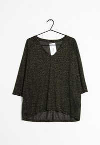 Haut noir avec des paillettes dorées, design en V, manches trois-quarts, coupe ample et ourlet incurvé. Le matériau semble léger et texturé.