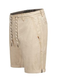 Beige cotton shorts with rolled hems, front zipper, and drawstring waistband featuring a checkered pattern. Side pockets included.