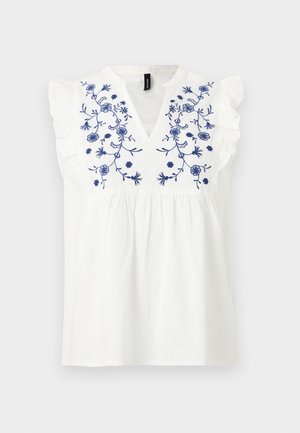 Blouse blanche sans manches avec broderie florale bleue sur la poitrine, détails à volants sur les épaules et encolure en V.