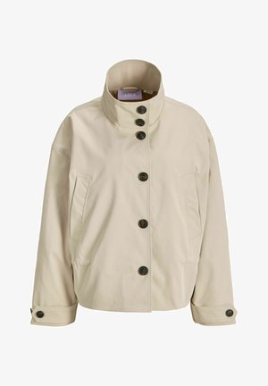 Veste beige à boutons avec col montant, deux poches latérales et poignets à boutons, en tissu lisse.