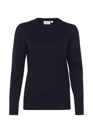 Tamsiai mėlynas mezginys su apvaliu iškirpimu, ilgomis rankovėmis ir grioveliais ant apačios ir rankovių. Pasižymi minkšta tekstūra ir subtiliu raštu audinyje.