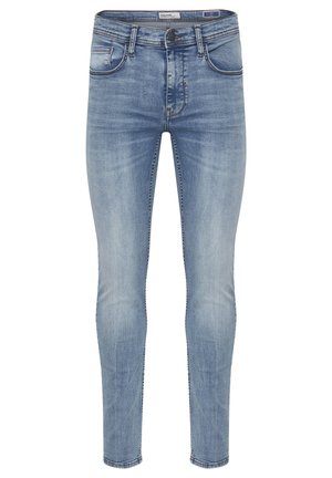 Jean skinny en denim bleu clair, avec un lavage délavé, cinq poches, une fermeture à bouton et des surpiqûres le long des coutures.