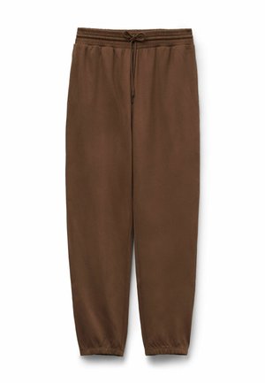 Braune Sweatpants mit elastischem Bund und verstellbarem Kordelzug. Schmal zulaufende Beine mit elastischen Bündchen an den Knöcheln. Weicher Stoff.