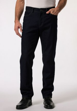 Dark blue denim jeans with a straight-leg cut, featuring yellow stitching, a front pocket, and a button closure. Worn with black shoes.