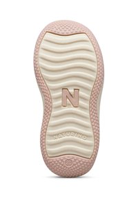 Suela de zapato de goma en crema con acentos rosas. Presenta una textura ondulada, pequeñas agarraderas circulares y el logo "NATURINO" en la base.