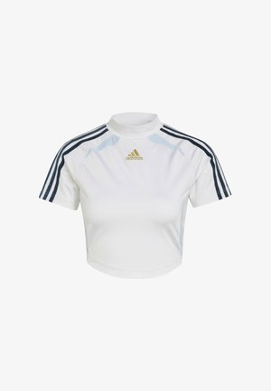 Witte, cropped sporttop met korte mouwen, voorzien van marineblauwe strepen en een hoge kraag. Goudkleurig "Adidas"-logo op de voorkant.