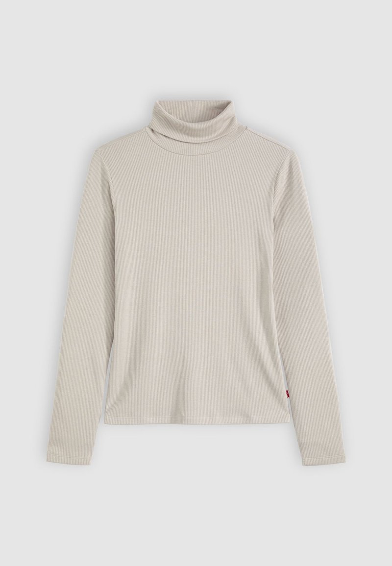 Helles beiger, geripptes Turtleneck-Oberteil mit langen Ärmeln, das ein körperbetontes Design und eine dezente Textur aufweist. Seitliches Etikett am Saum sichtbar.