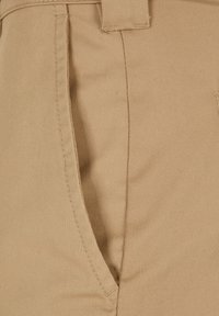 Beige fabric pants featuring a smooth texture, side pocket, and stitched detailing. The material appears sturdy and durable.