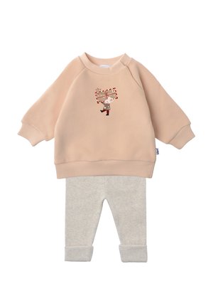 Light pink sweatshirt with ribbed cuffs featuring a cartoon character holding a gift, paired with light gray cuffed leggings in soft fabric.
