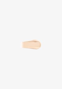 Beige liquid foundation swatch smoothed in an elongated, curved shape on a white background.