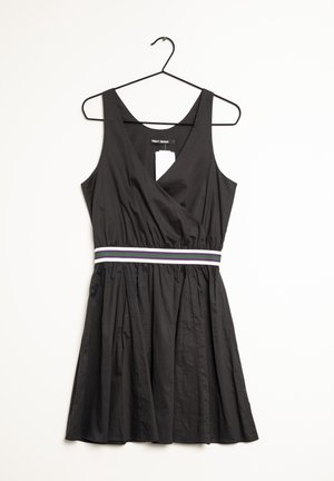 Black sleeveless dress with V-neck, elastic waistband featuring white, purple, and green stripes, hanging on a black hanger.