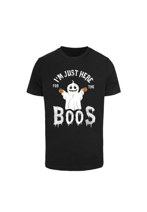 Black t-shirt featuring a white ghost graphic holding pumpkins, with "I'M JUST HERE FOR THE BOOS" in bold, dripping font.