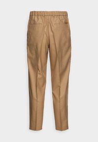 Pantalon beige à taille élastique, avec deux poches arrière et un tissu lisse et texturé. Conception ajustée, forme jambe droite.