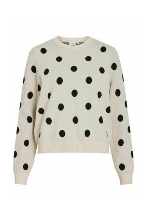 Hele beež värvusega kampsun mustade täppidega, ümar kaelus ja soonilised varrukaotsad. Pehme kootud tekstuuriga, lõdva istuvusega ja ilma nähtavate kinnitusteta.