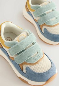 Velcro sneakers featuring a mix of light blue, mint green, tan, and cream mesh material; suede accents; and a rubber sole.