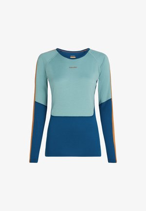 Long-sleeve, color-blocked shirt with light blue upper, dark blue lower, and brown stripes on sleeves, featuring a small "Icebreaker" logo.