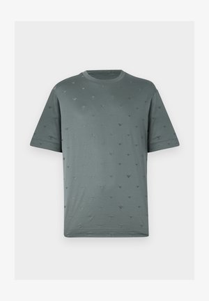 Short-sleeve, crew-neck t-shirt in muted green with subtle embossed pattern of small dark gray triangles throughout the fabric. Soft texture.
