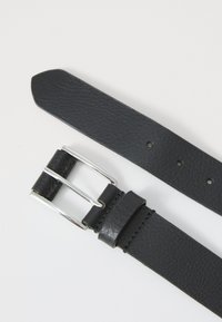 Black leather belt with silver metal buckle and multiple adjustment holes on white background.