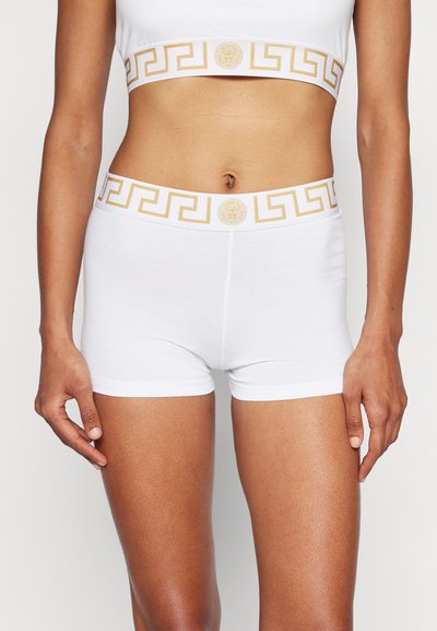 Bílé bavlněné boxerky s zlatým řeckým vzorem na pase a centrálním emblémem. Hladká textura a přiléhavý design.