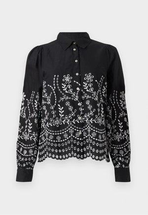 Black long-sleeve blouse with white floral embroidery, button-down front, scalloped hem, and slightly puffed shoulders.