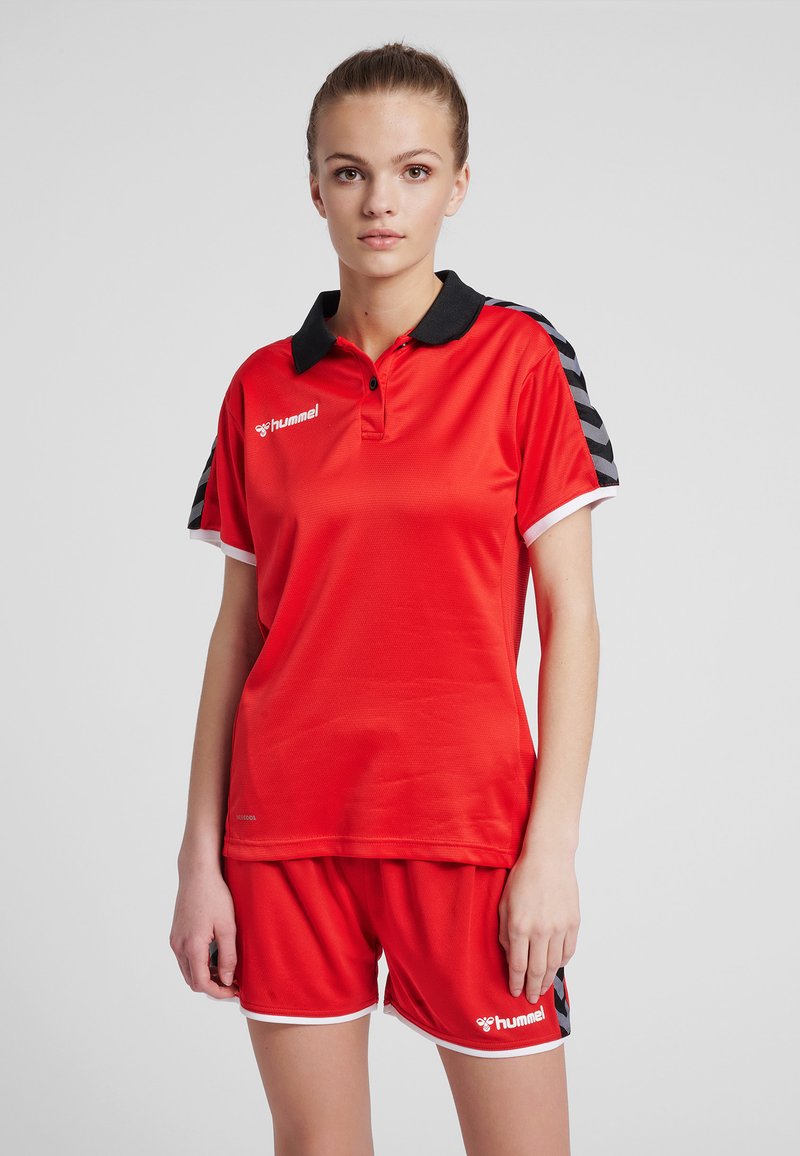Red sports outfit comprising a short-sleeve polo with a black collar and red shorts, featuring a white trim and black stripes on the sleeves.