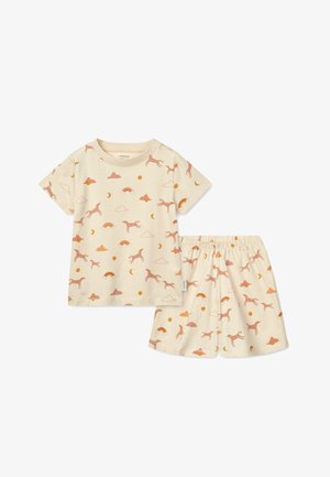 Pamut pizsama szett, amely rövid ujjú topból és rövidnadrágból áll, krémszínben, rózsaszín unikornissal, felhőkkel, nappal és hónappal díszítve. Rugalmas derekú.