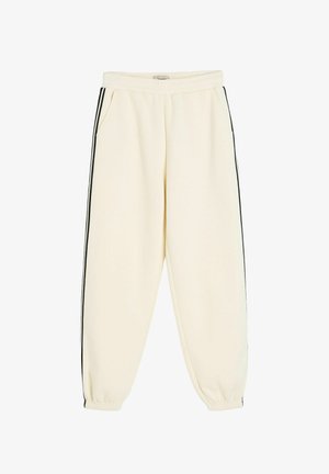 Kremowe spodnie dresowe z elastycznym pasem i ściągaczami u dołu, z czarnymi paskami po bokach i przednimi kieszeniami.