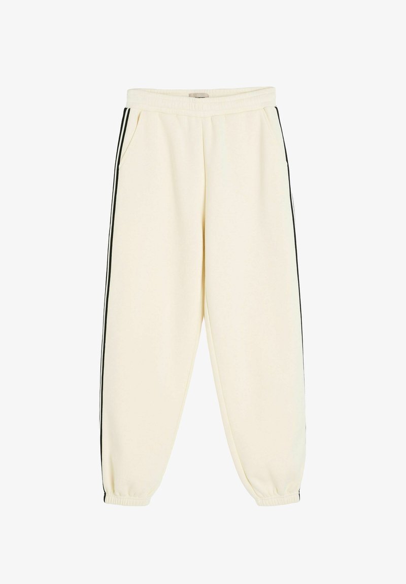 Kremowe spodnie dresowe z elastycznym pasem i ściągaczami u dołu, z czarnymi paskami po bokach i przednimi kieszeniami.