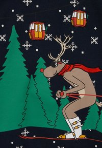 Tecknad ren som åker skidor, bär solglasögon och en röd halsduk, mot en mörk bakgrund med gröna tallar och snöflingemönster.